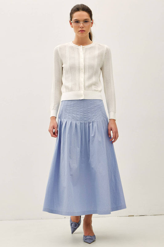 White pointelle cropped cardigan styled with blue midi skirt