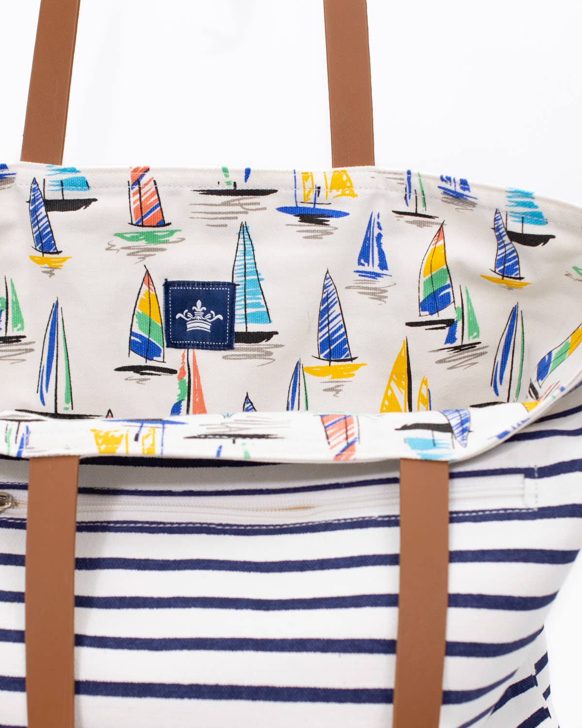Open reversible tote showing sailboat print lining and striped exterior