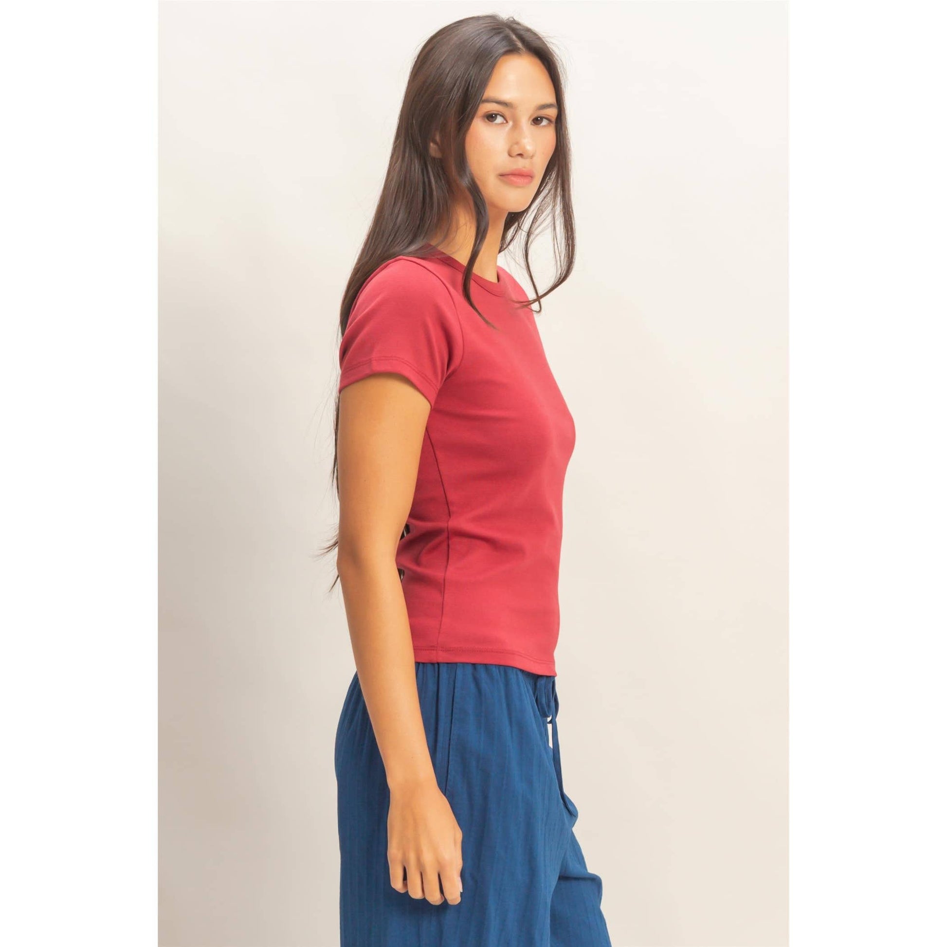 Side view of rose crew neck short sleeve top with fitted sleeves