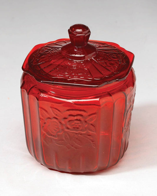 Ruby red glass cookie jar with embossed floral panels and matching lid