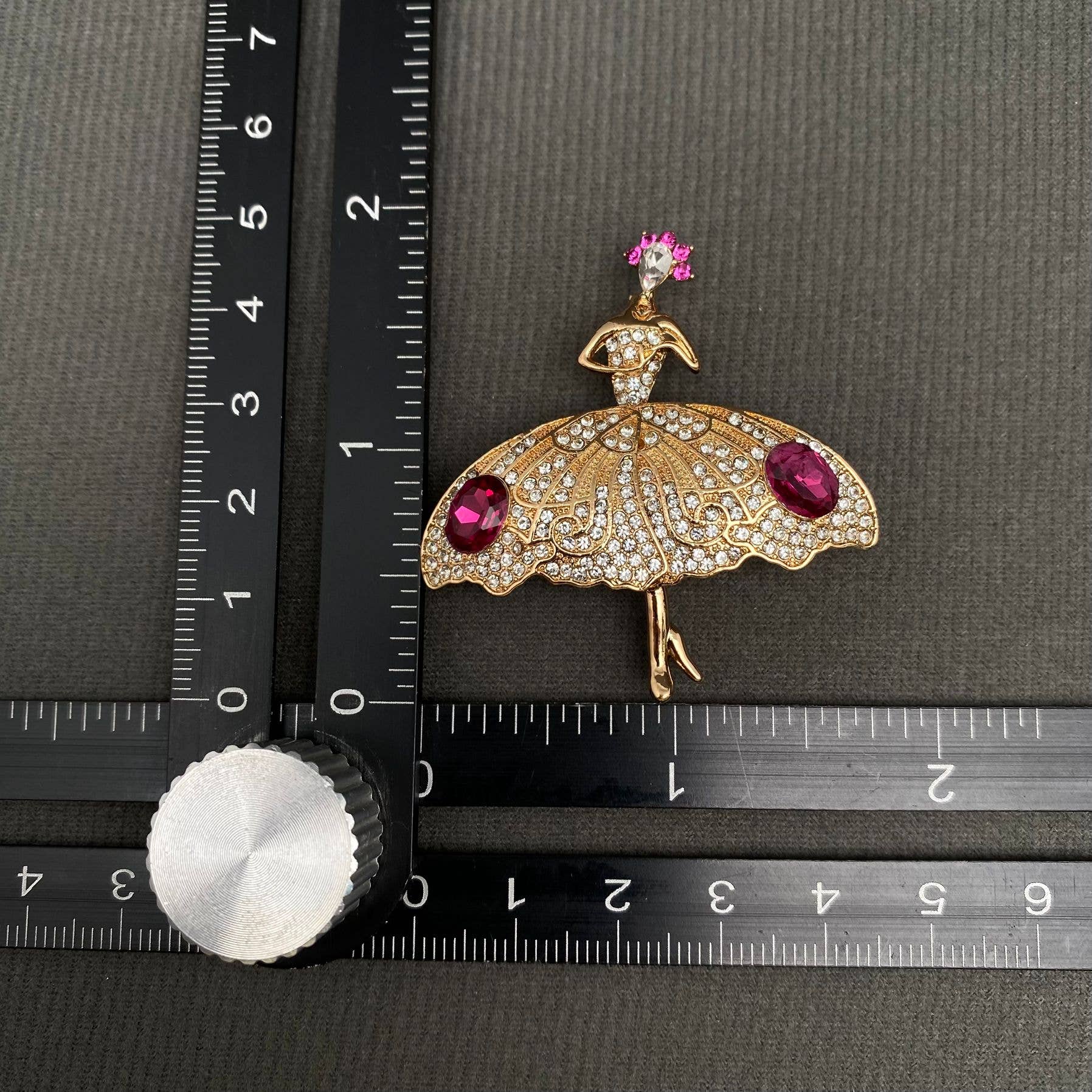 Ballet dancer rhinestone brooch measured beside ruler