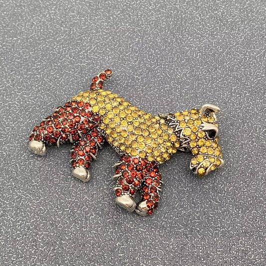 Decorative horse figure with red and yellow stones on a textured gray background