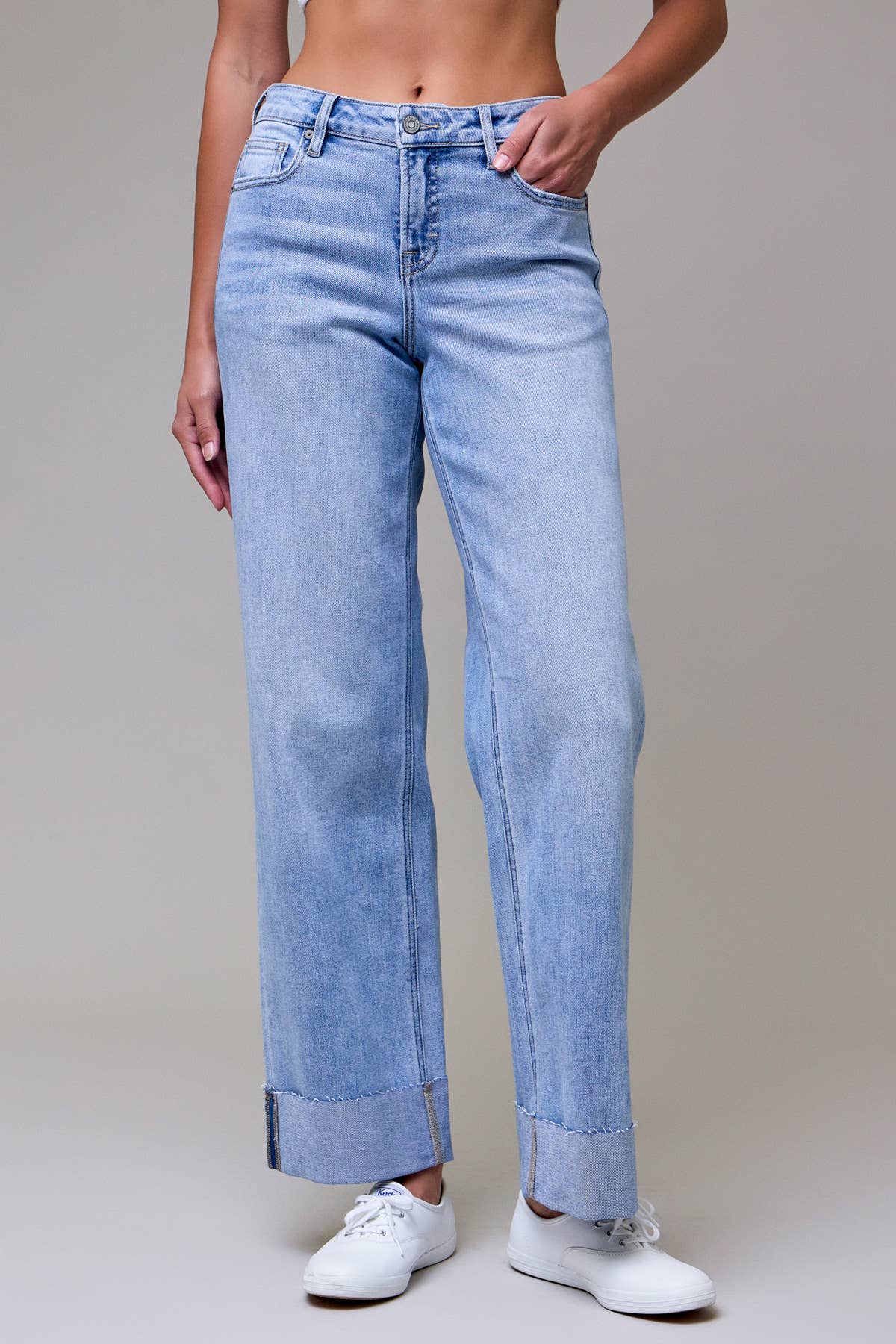 Light blue jeans worn by a person on a neutral background