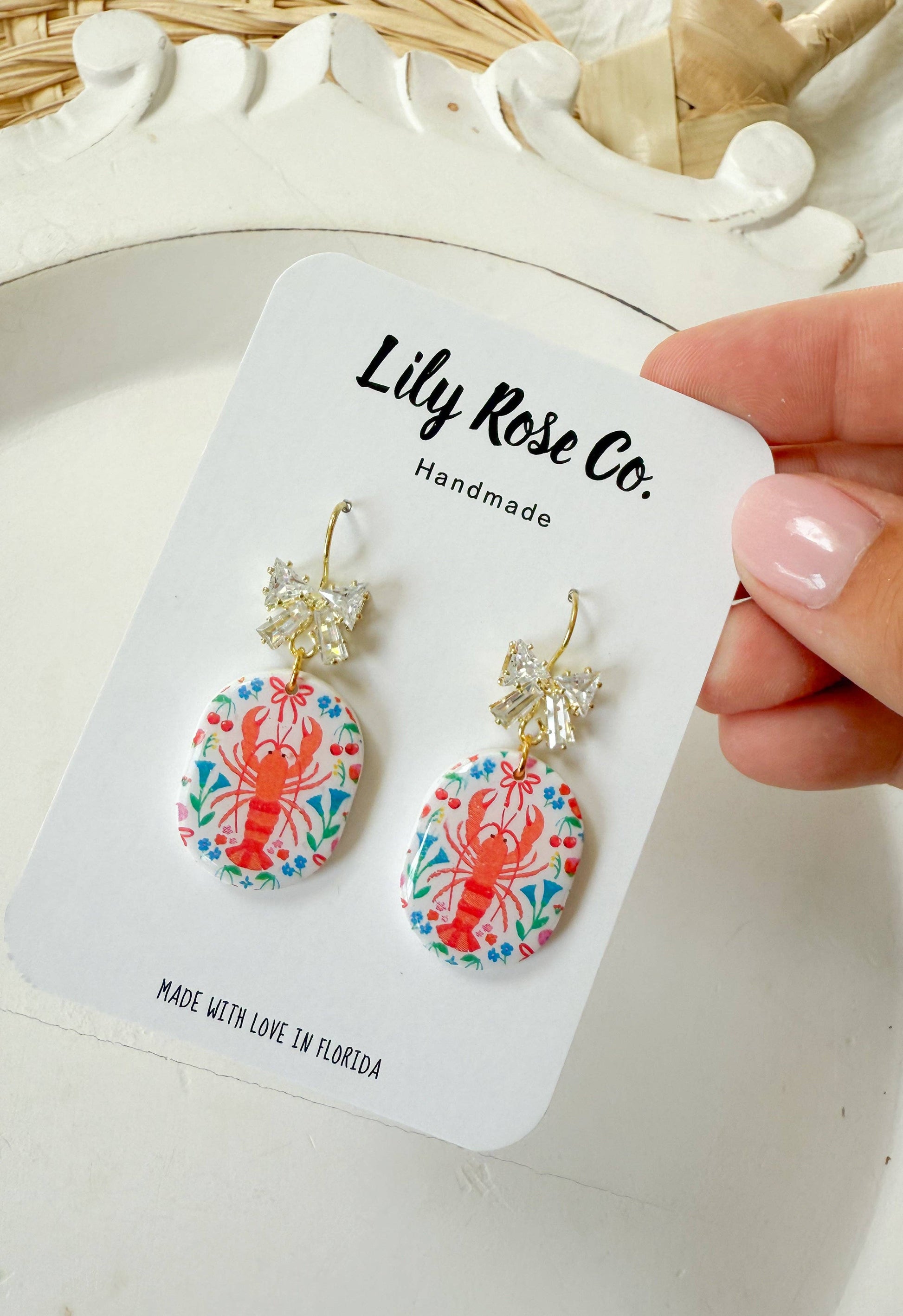 Round lobster print earrings with clear bow-style connectors