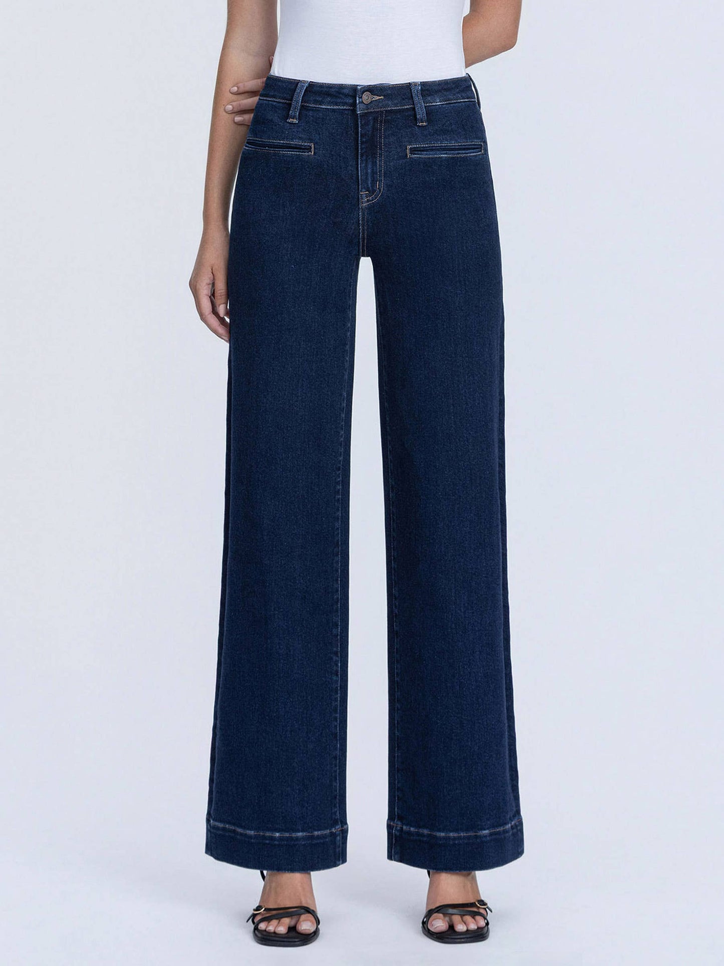 Front detail of dark denim trouser jeans with welt pockets