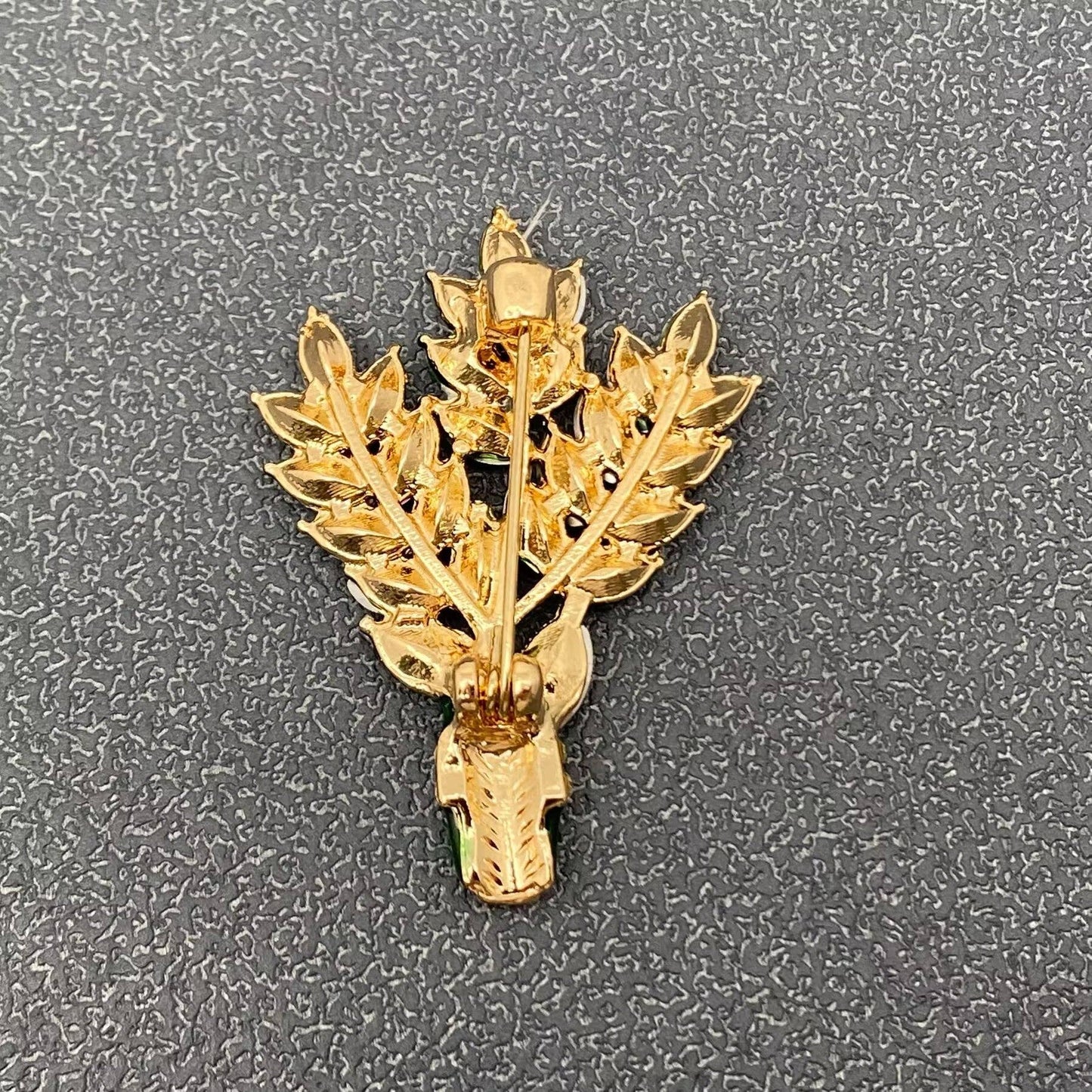 Gold-tone back of lavender floral brooch with pin clasp