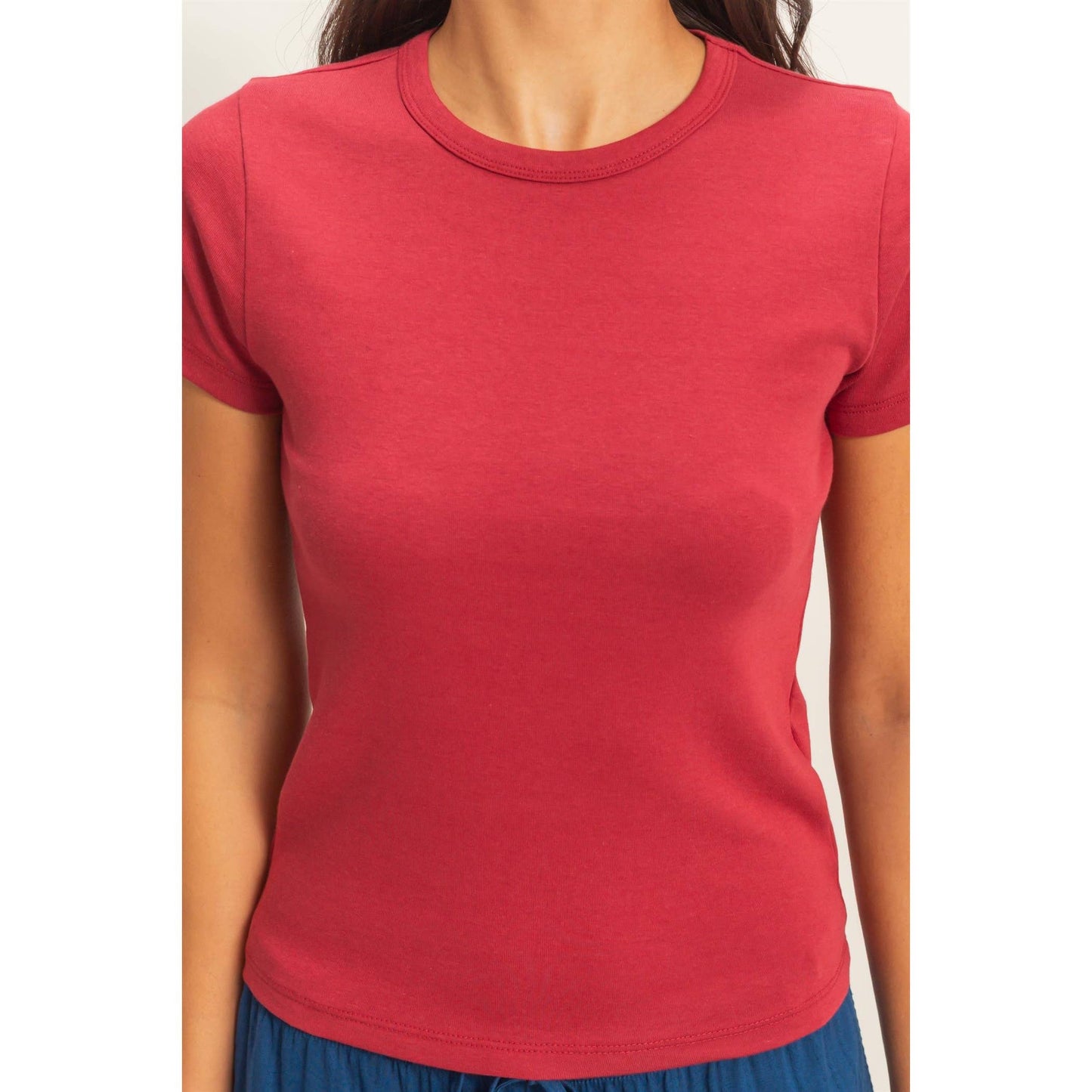 Close-up of rose crew neck short sleeve top showing neckline and hem