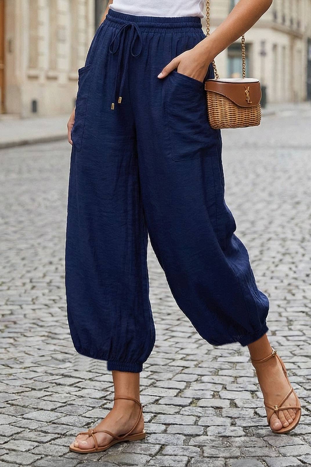 Close-up of navy harem pants with drawstring waist and elastic cuffs