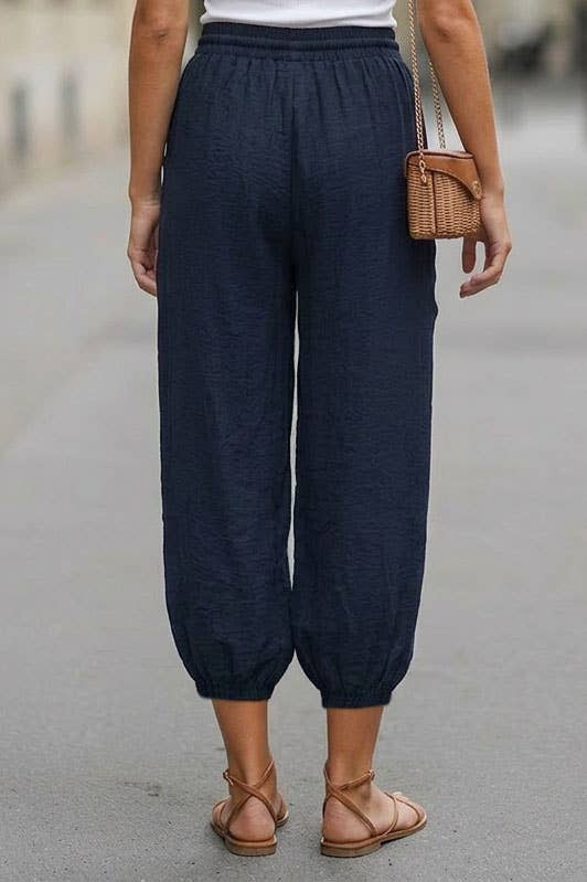Back view of navy harem pants with elastic waist and cuffs