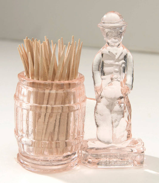 Pink glass toothpick holder with barrel cup and standing man figure