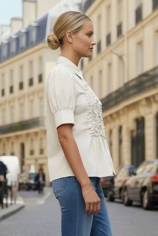 Side view of off white ruched blouse with short puff sleeve
