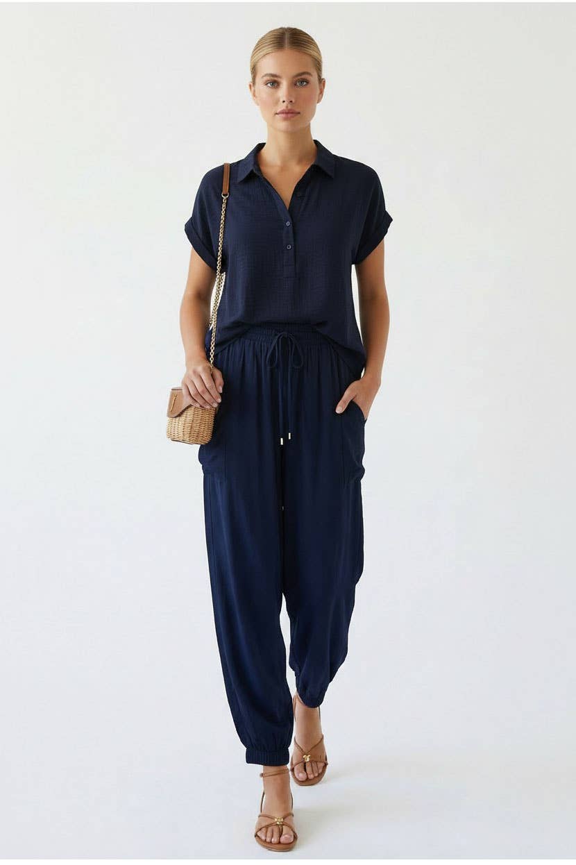 Navy relaxed harem pants with drawstring waist on a studio model