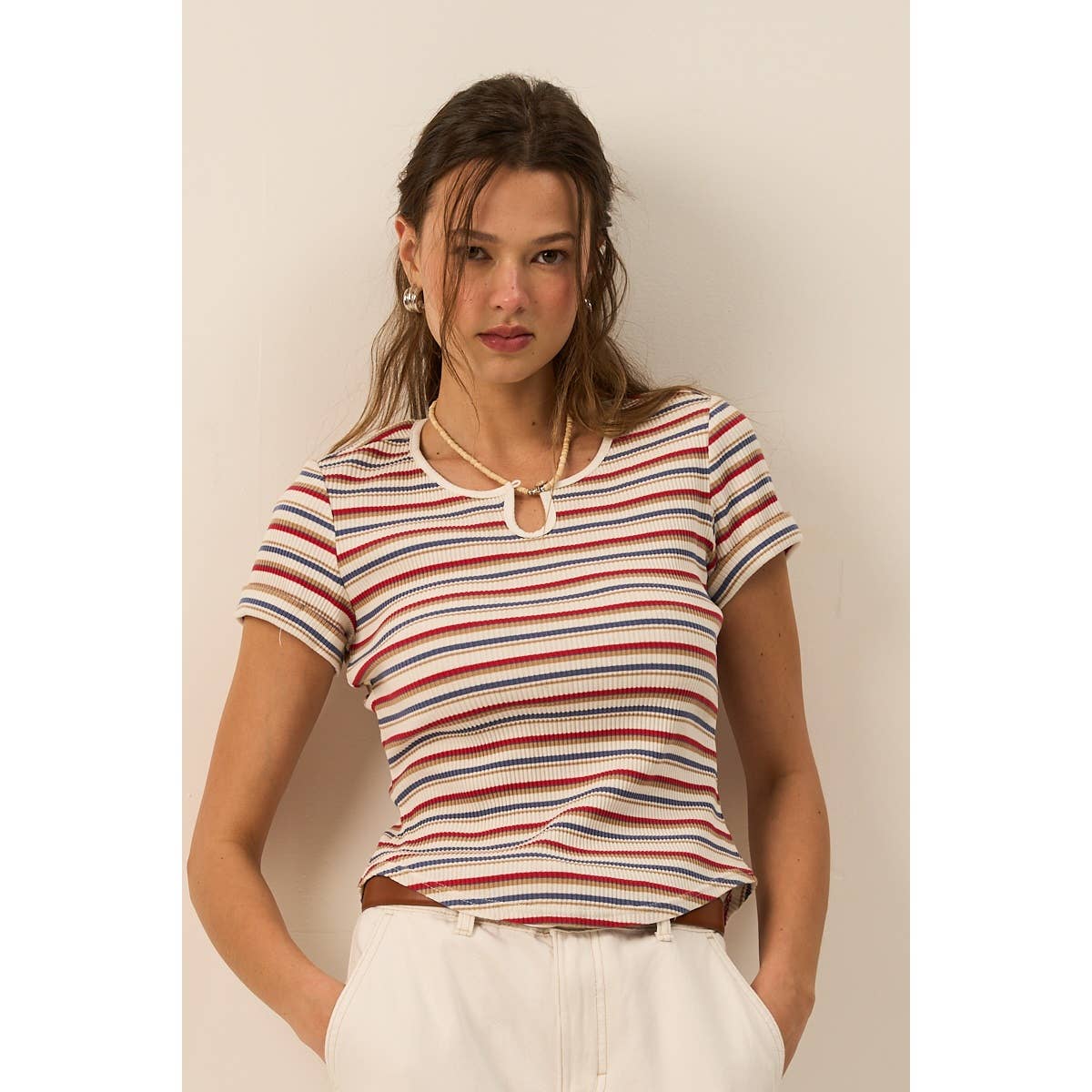 Woman wearing a striped shirt against a plain background