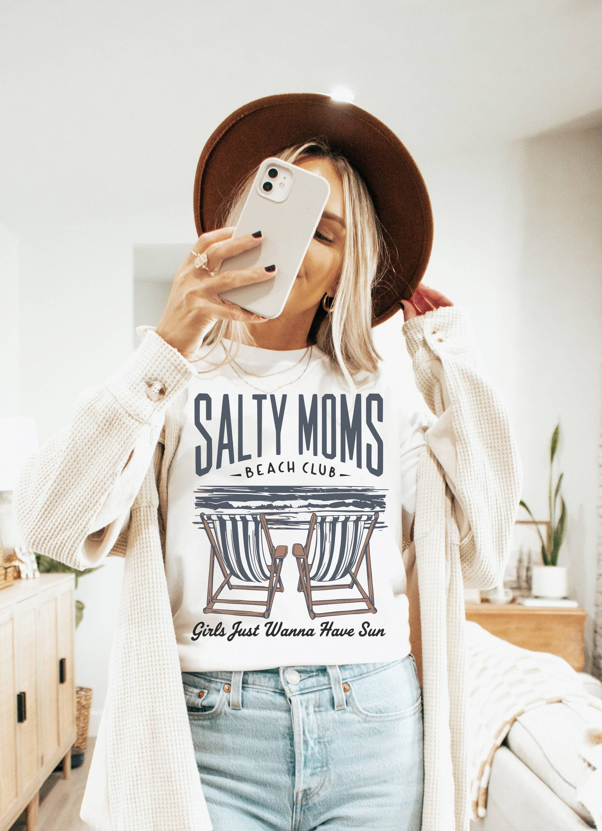 Person wearing a 'Salty Moms' t-shirt and taking a mirror selfie.