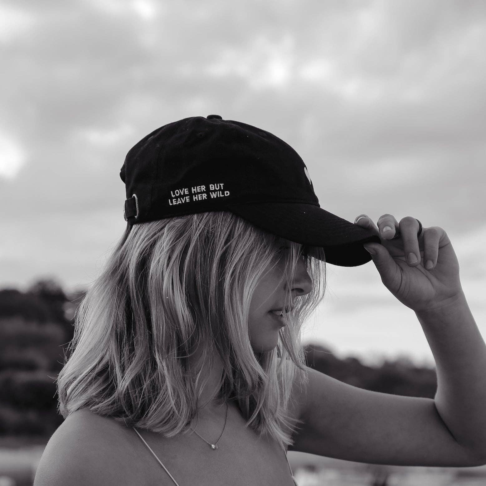 Black dad hat with embroidered side slogan on model