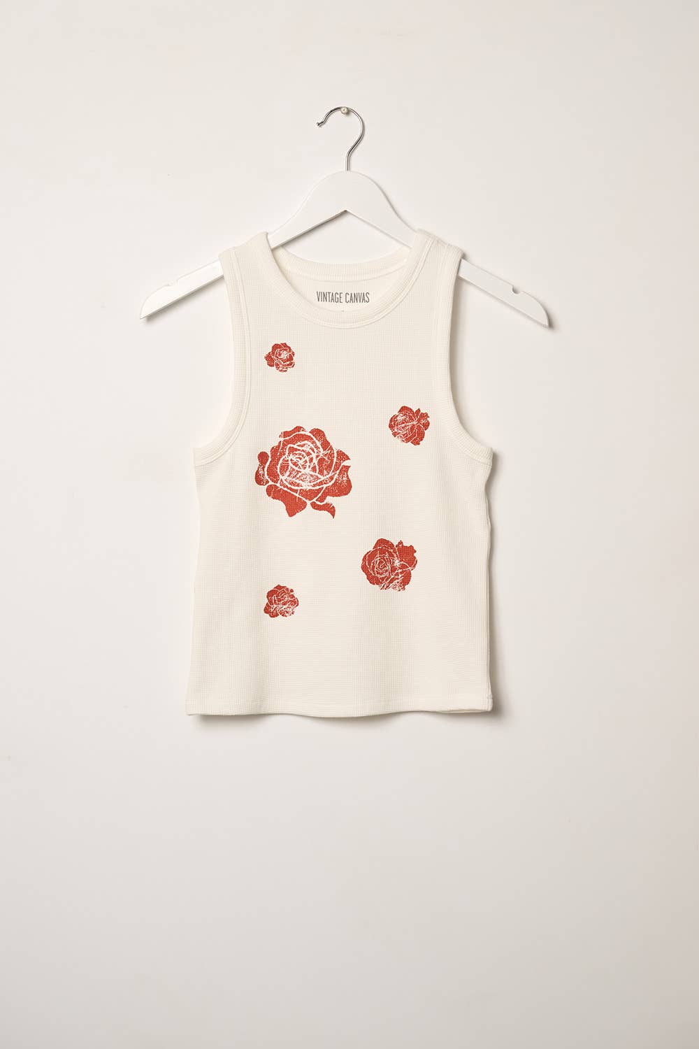 White tank top with red floral patterns on a white background