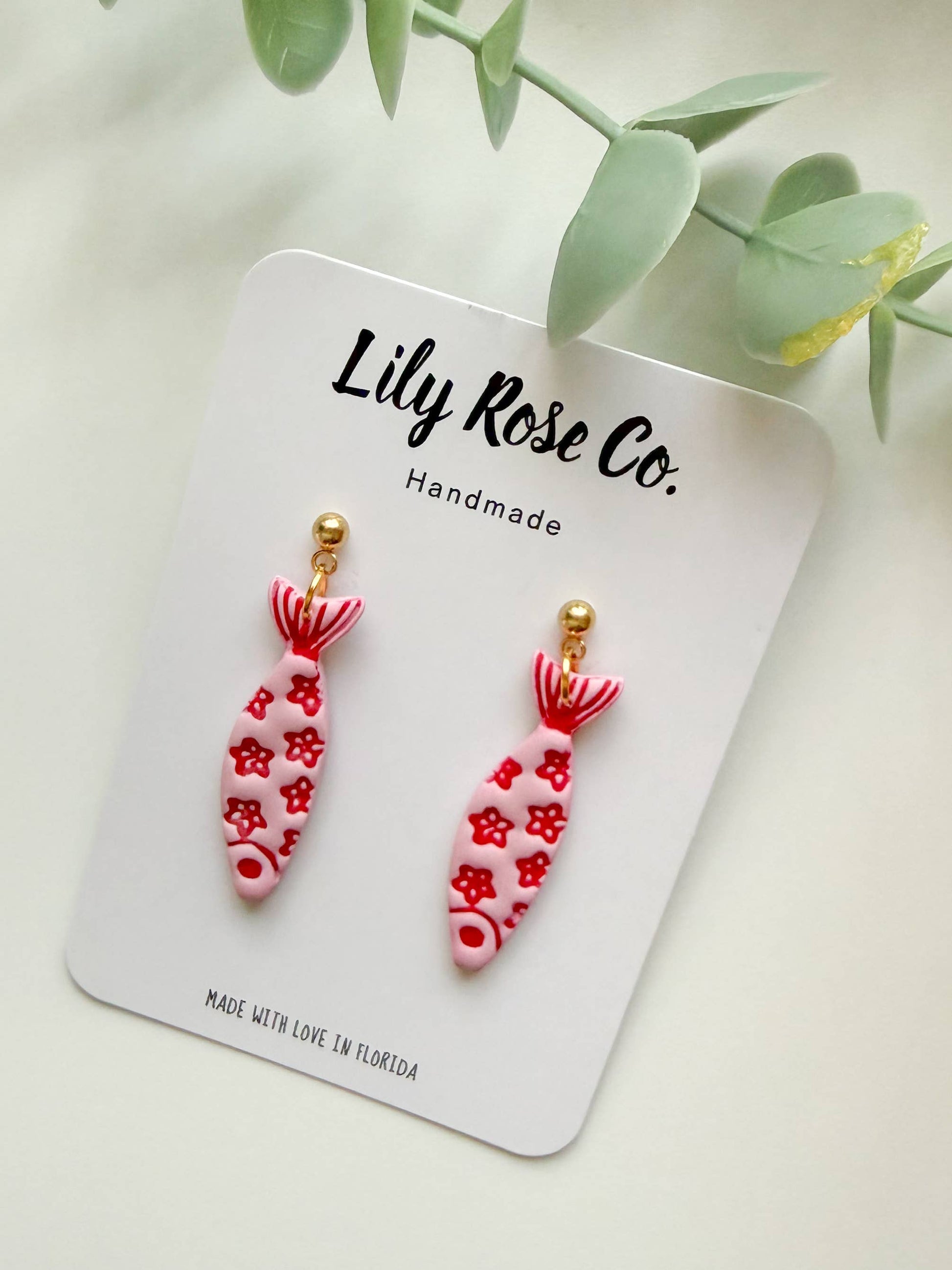 Pink fish drop earrings with red floral pattern
