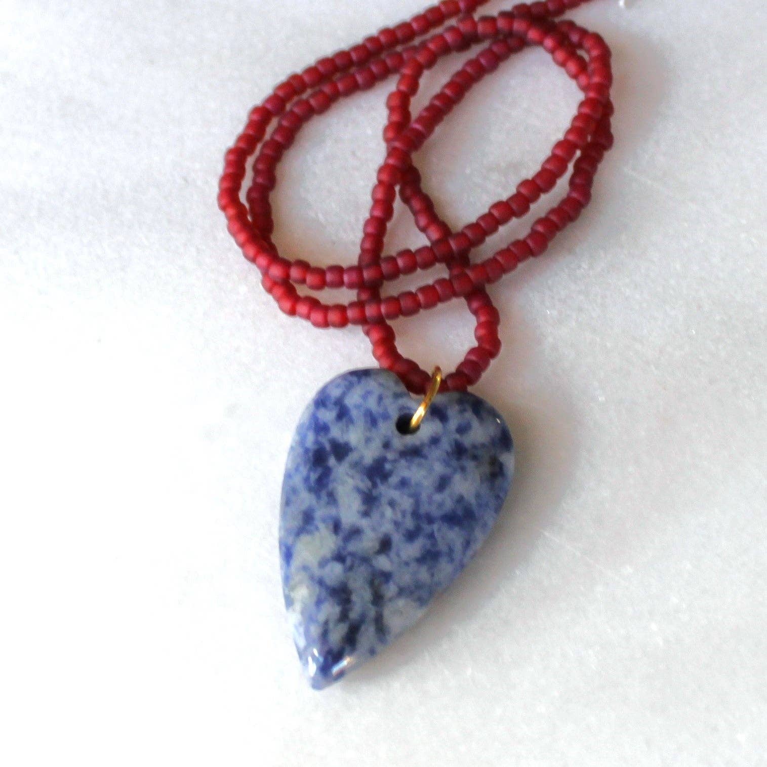 Blue speckled heart pendant necklace with rust red seed beads