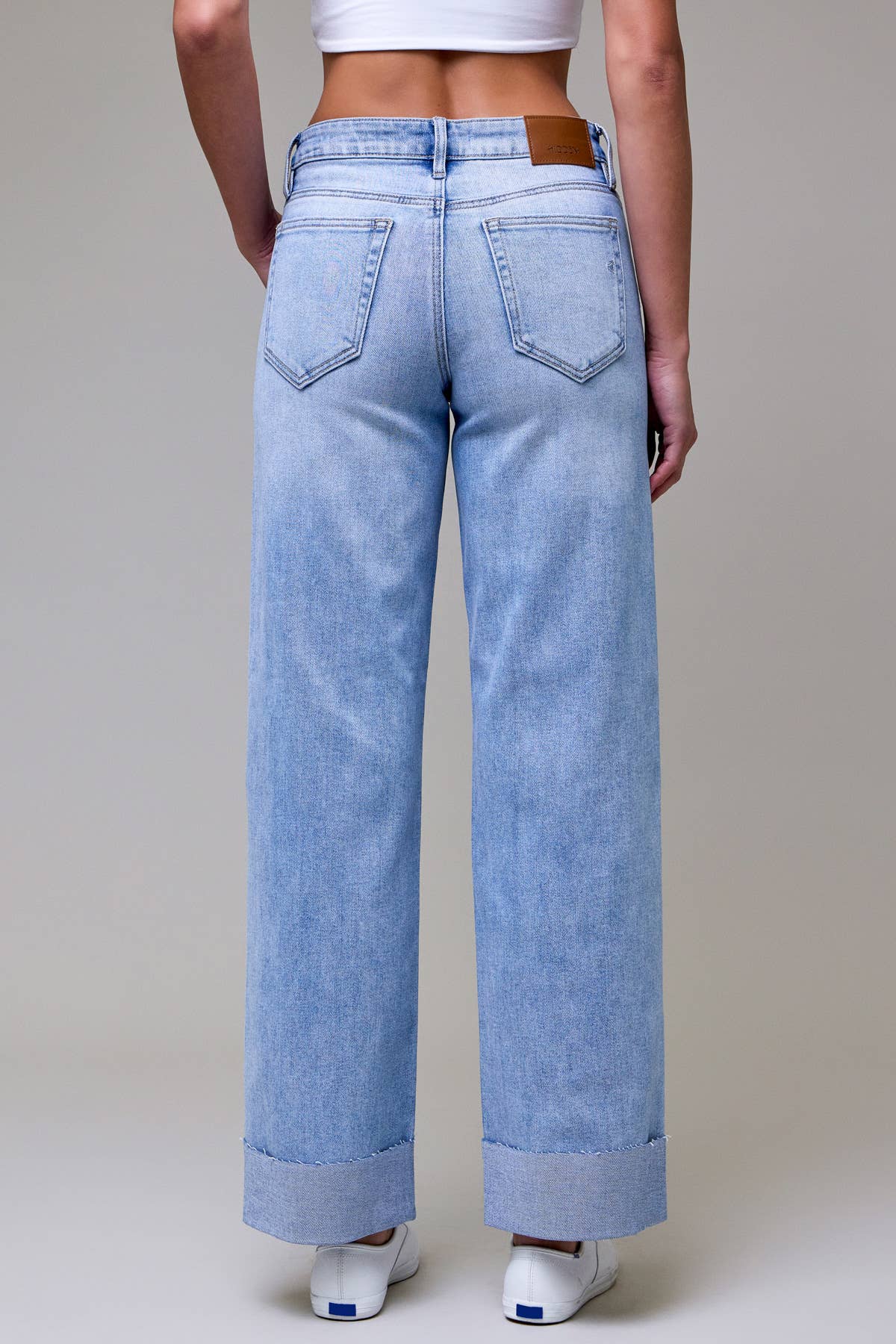 Light blue jeans worn by a person on a plain background
