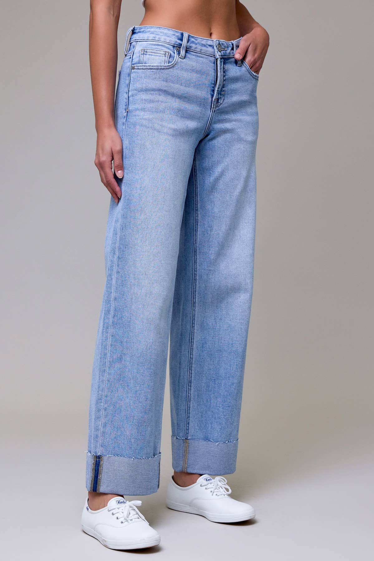 Light blue jeans worn by a person on a plain background