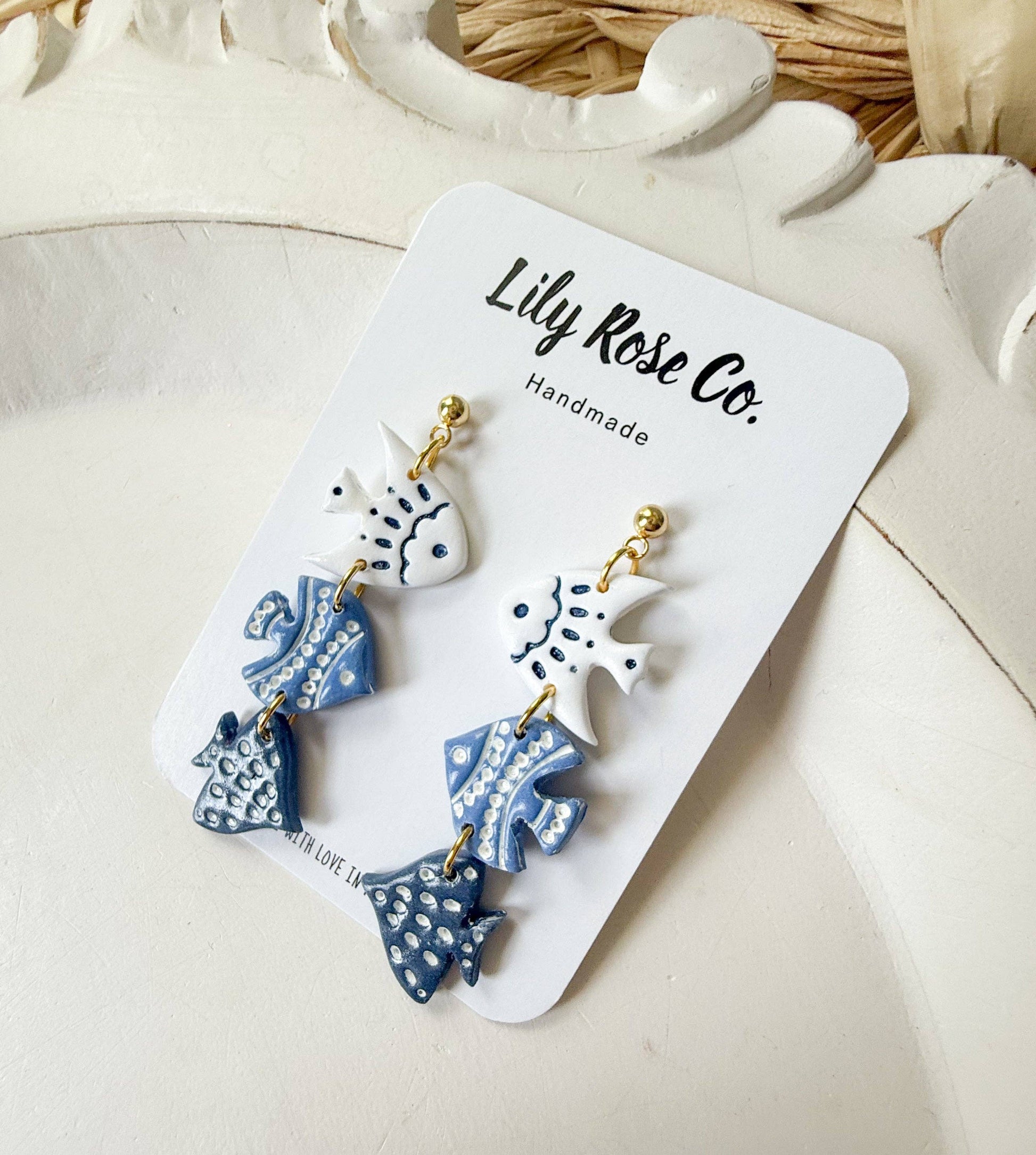 Blue and white three-tier fish drop earrings with gold-tone connectors