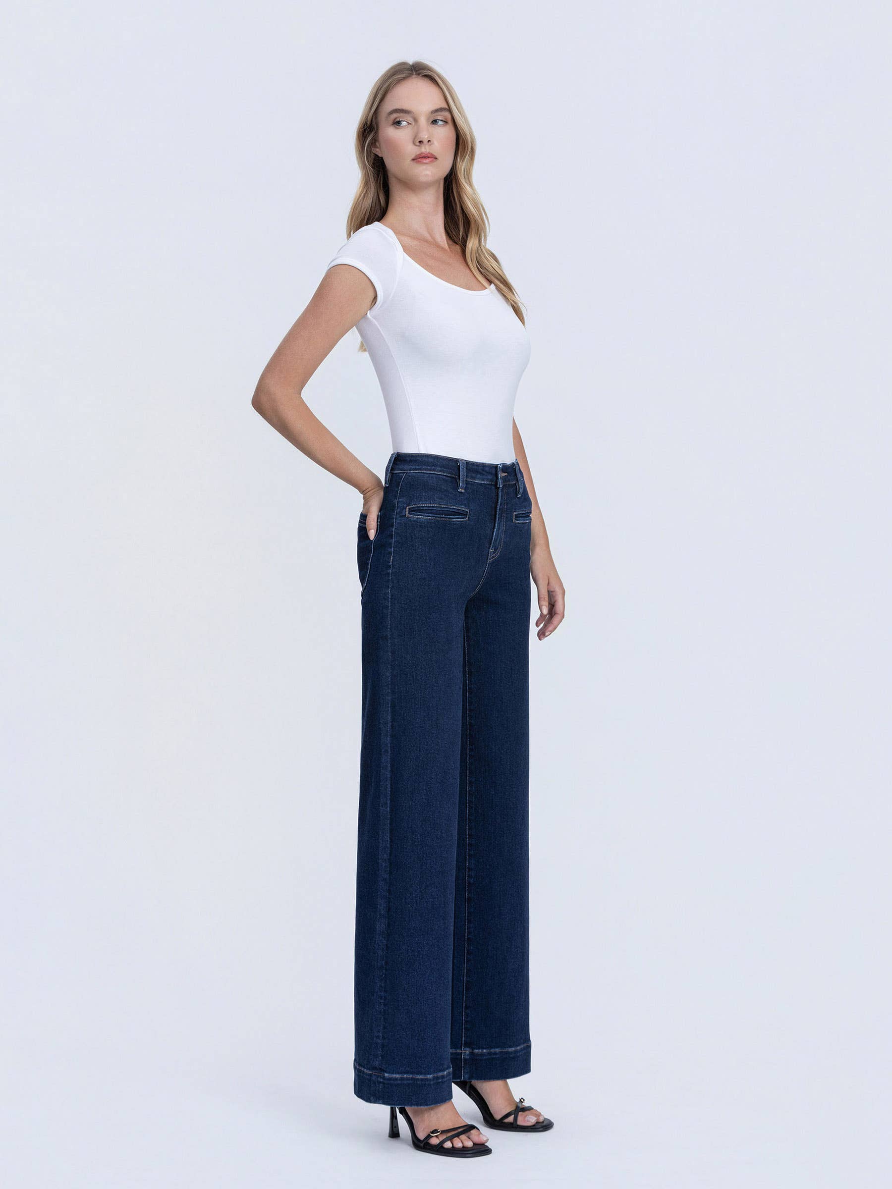 Angled waist view of dark denim trouser jeans