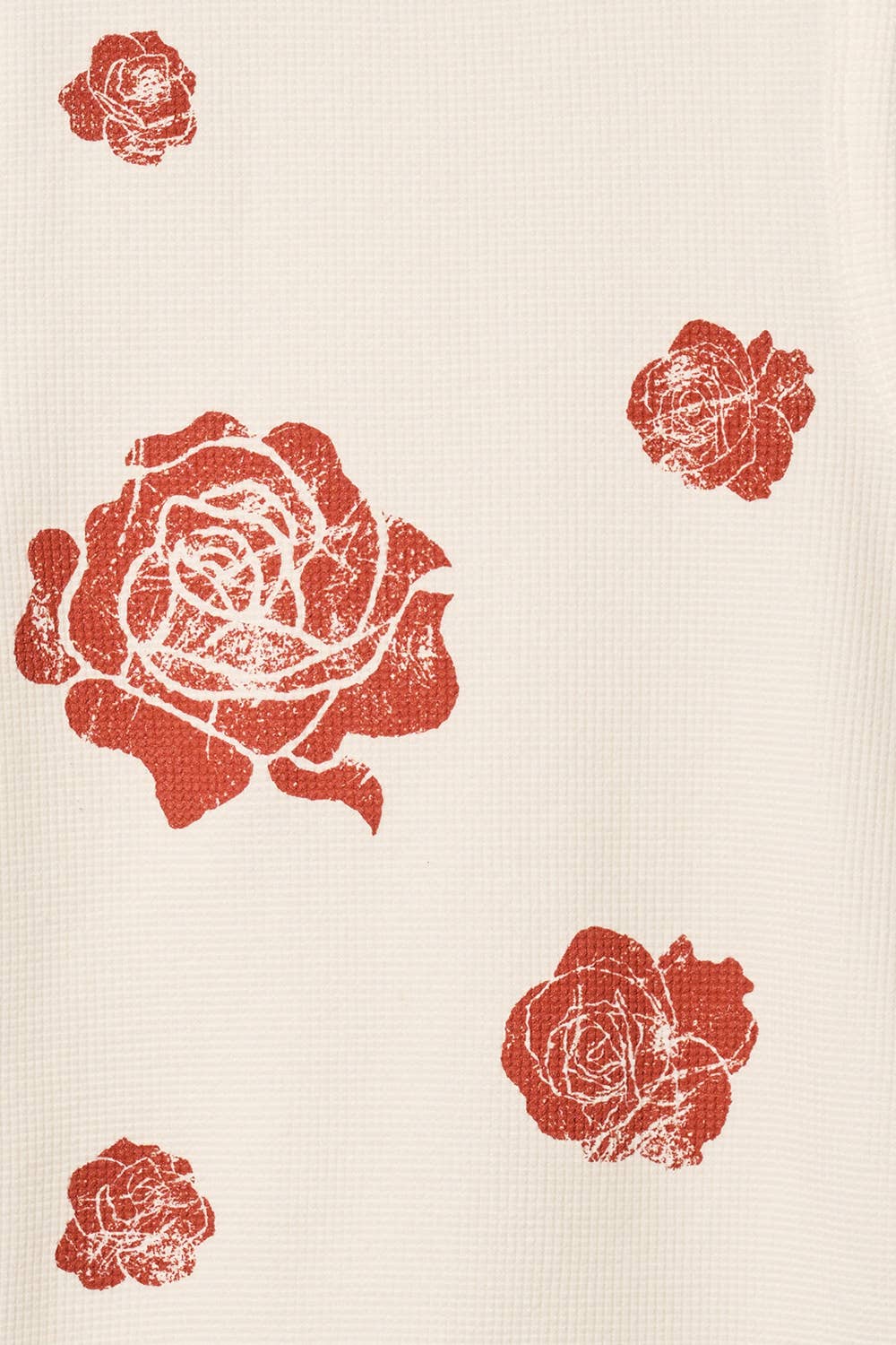Red rose prints on a beige fabric background