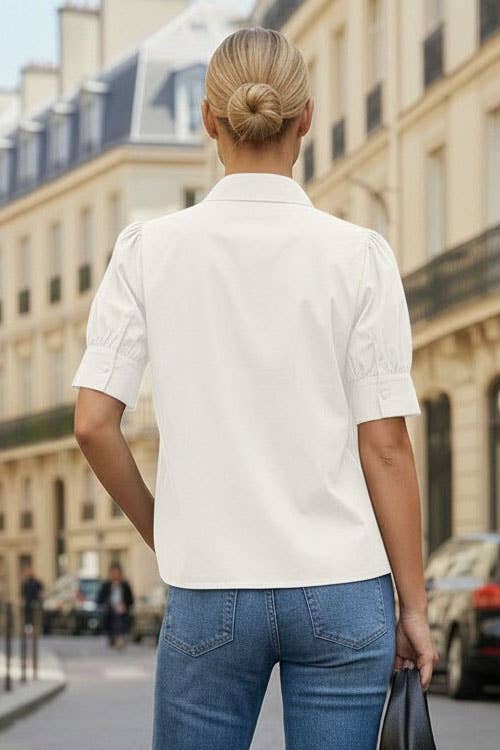 Back view of off white button-up blouse with short puff sleeves