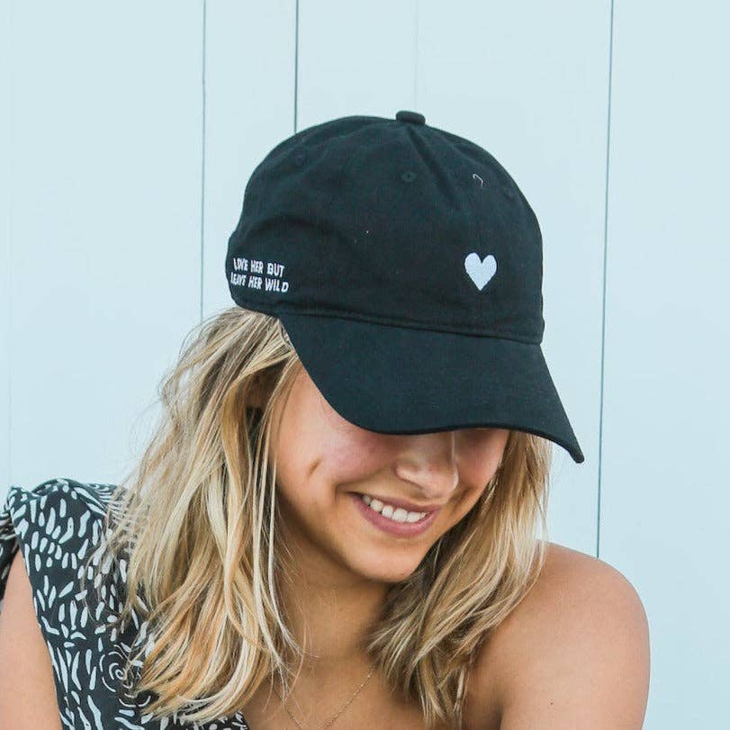Black dad hat with heart and side slogan on model