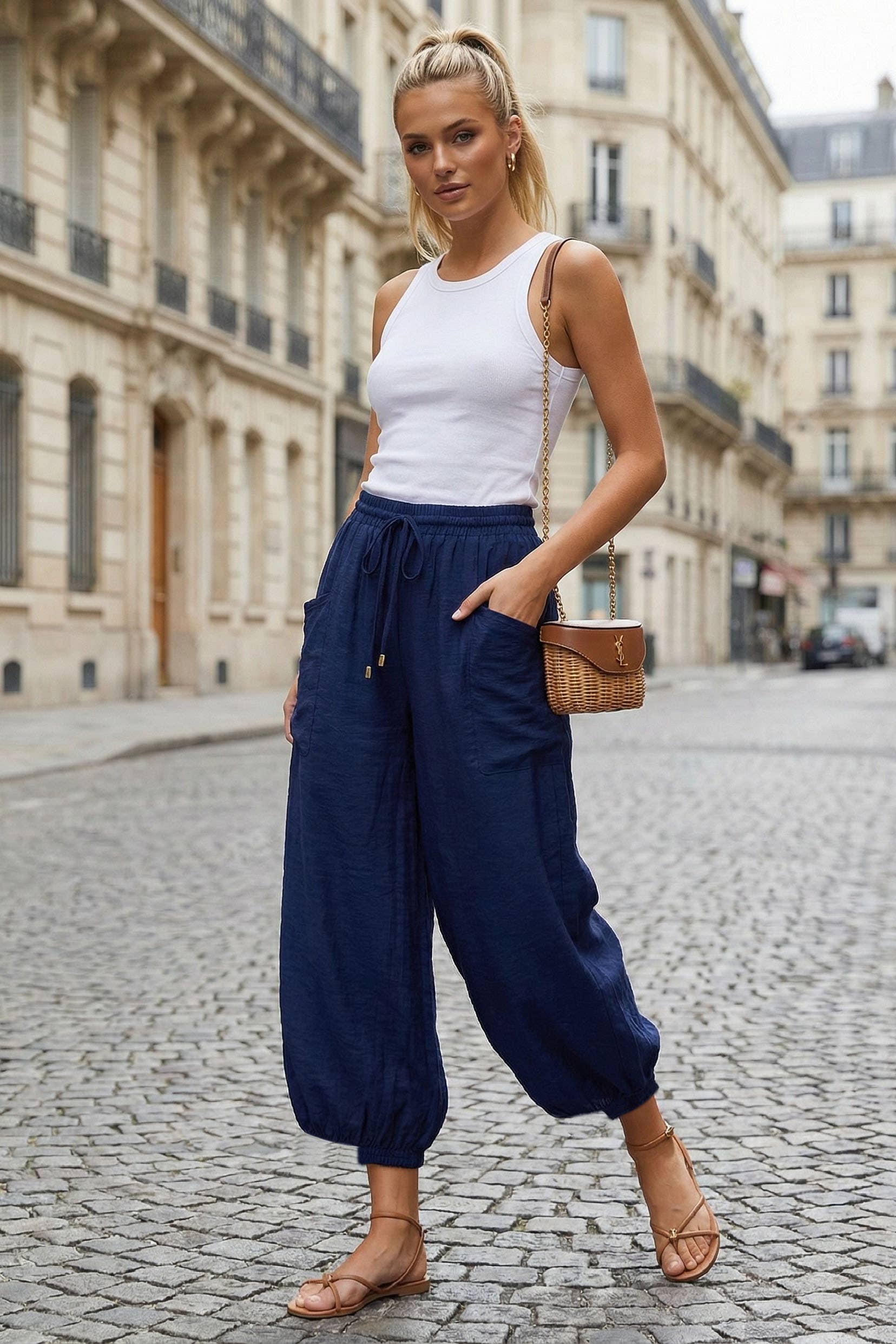 Navy harem pants with drawstring waist and elastic cuffs styled on model