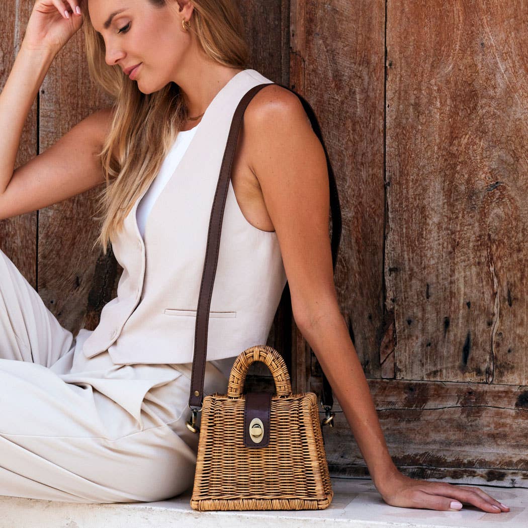 Petite rattan handbag with top handle and brown strap
