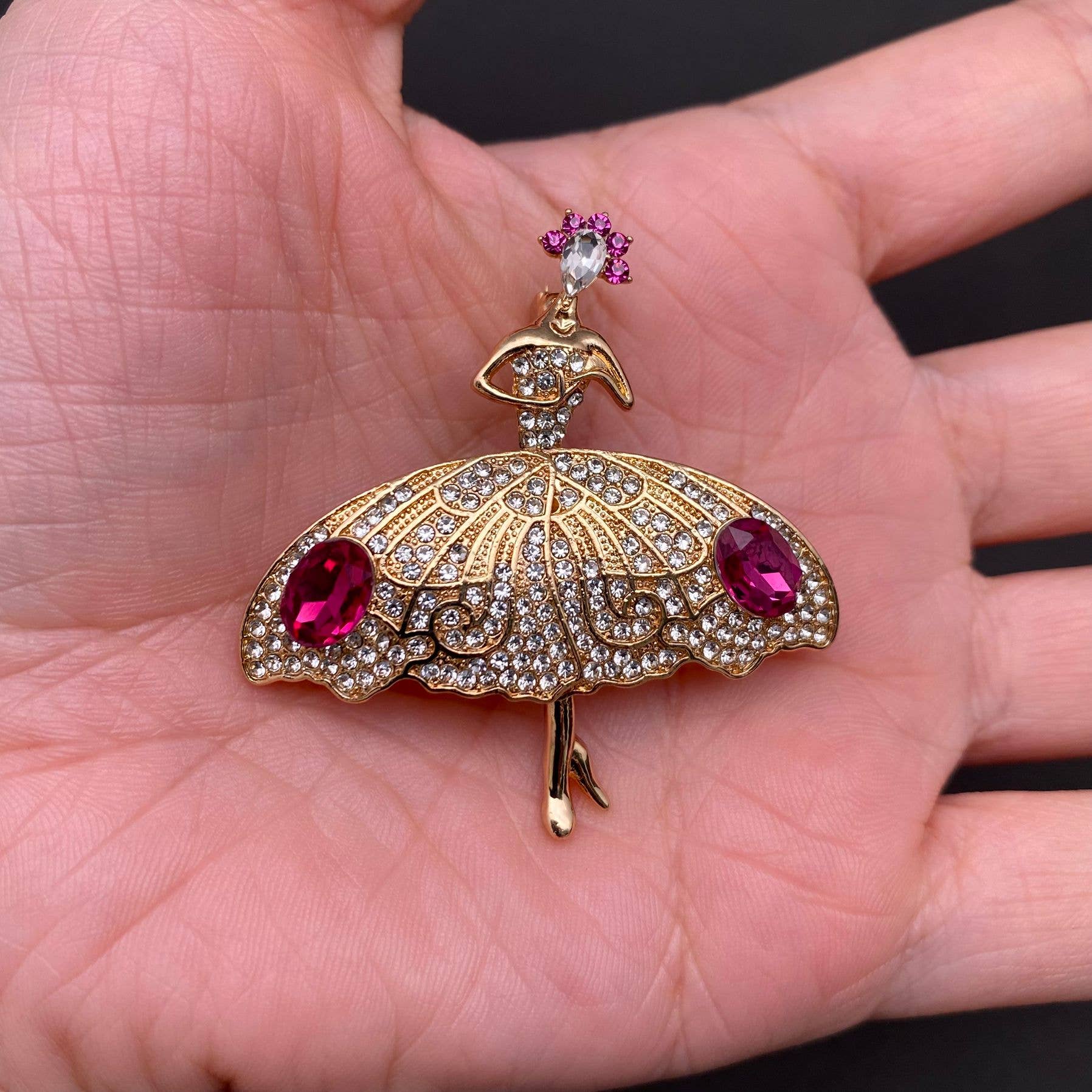Ballet dancer rhinestone brooch shown in hand for scale