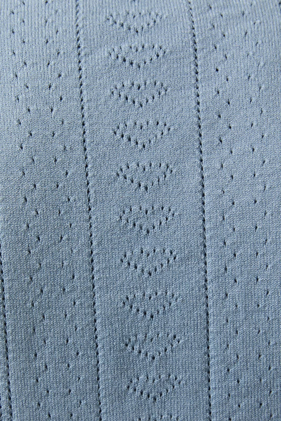 Close-up of textured blue fabric with a subtle pattern