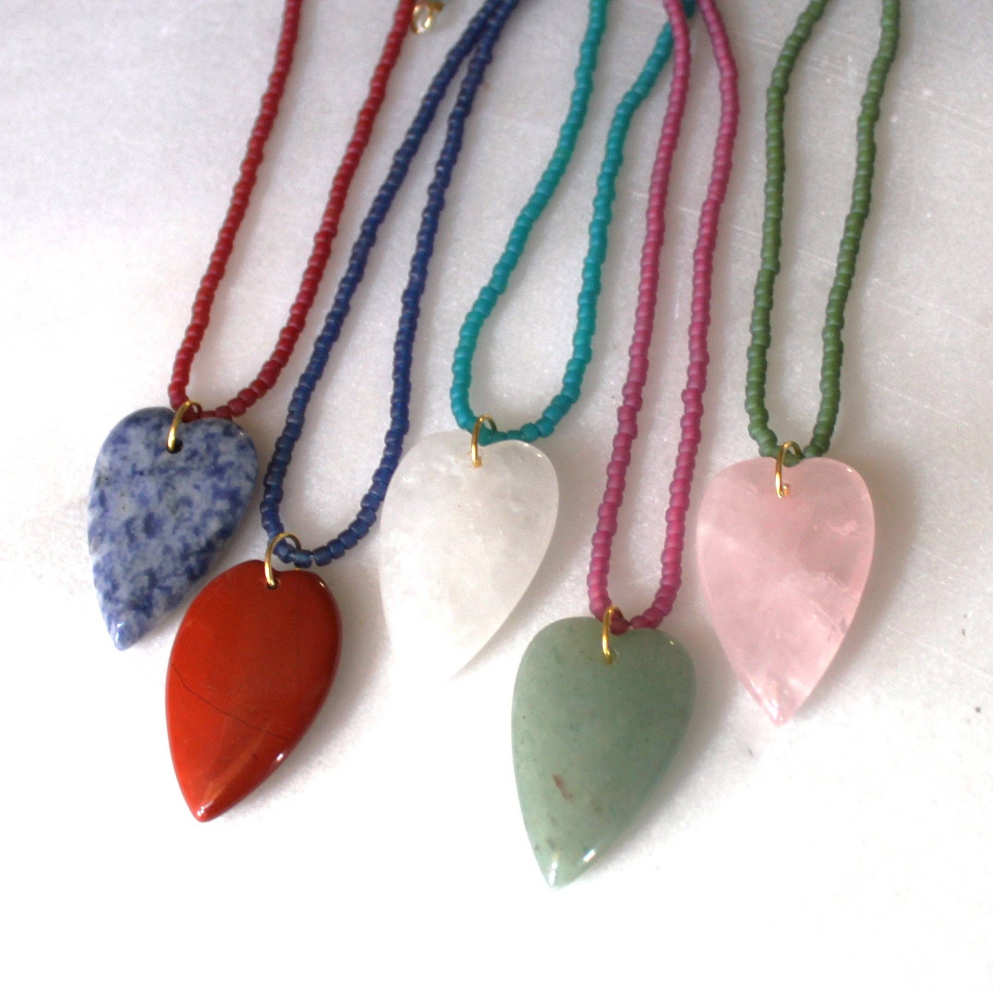 Close-up of colorful seed bead strands with heart pendants
