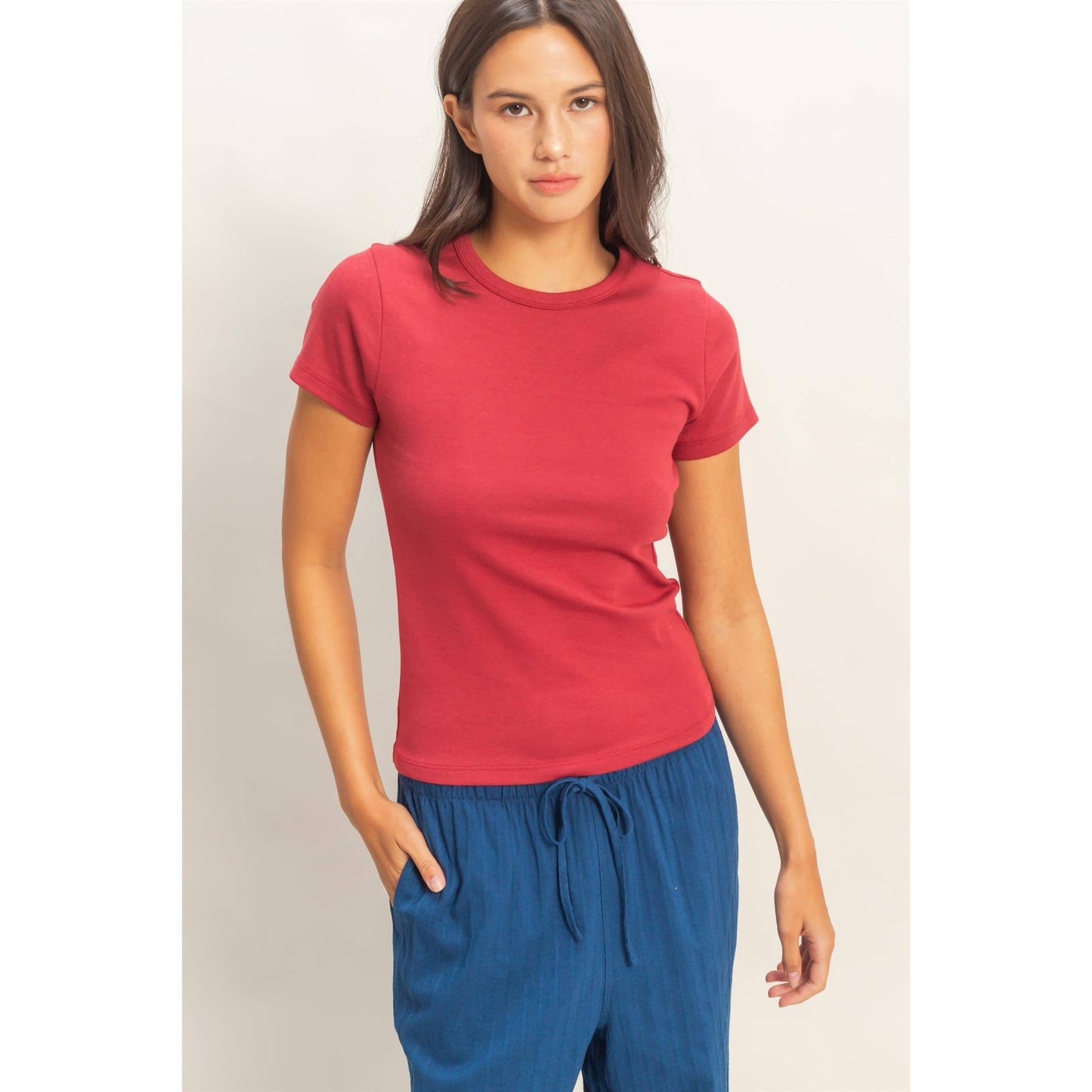 Front view of rose crew neck short sleeve top styled with blue drawstring pants